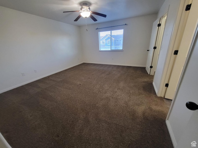 3318 E Quarter Mile Dr, Eagle Mountain, UT 84005 - unfurnished bedroom featuring a ceiling fan, dark colored carpet, and baseboards