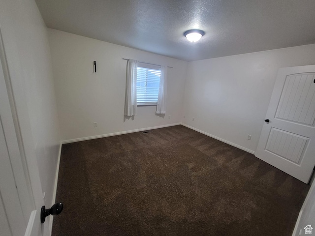 3318 E Quarter Mile Dr, Eagle Mountain, UT 84005 - unfurnished room featuring dark colored carpet and baseboards