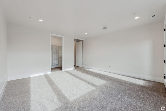 3097 E Corral Peak Cir Unit 145, Heber City, UT 84032 - unfurnished bedroom featuring baseboards, a walk in closet, light colored carpet, and recessed lighting