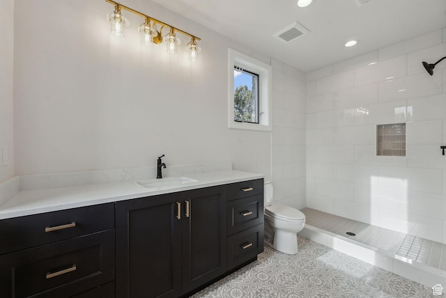 3097 E Corral Peak Cir Unit 145, Heber City, UT 84032 - bathroom featuring toilet, visible vents, a tile shower, and tile patterned floors