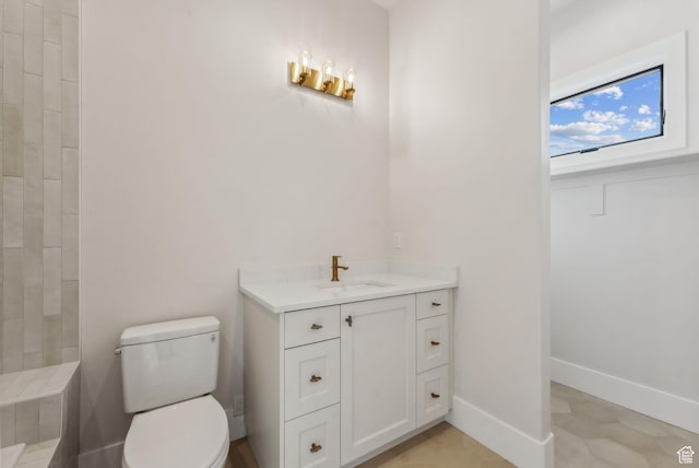3097 E Corral Peak Cir Unit 145, Heber City, UT 84032 - bathroom featuring toilet, vanity, and baseboards
