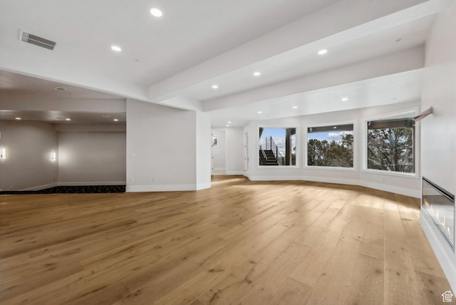3097 E Corral Peak Cir Unit 145, Heber City, UT 84032 - unfurnished living room featuring visible vents, baseboards, light wood-type flooring, and recessed lighting