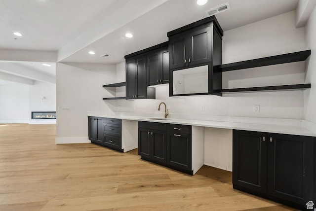 3097 E Corral Peak Cir Unit 145, Heber City, UT 84032 - kitchen featuring a sink, visible vents, light wood-style flooring, and open shelves