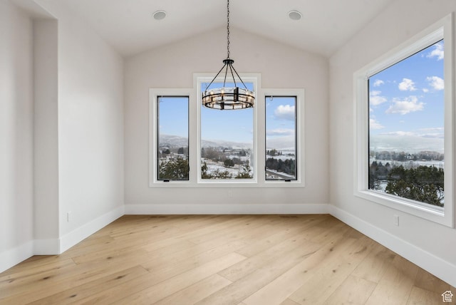 3097 E Corral Peak Cir Unit 145, Heber City, UT 84032 - unfurnished dining area featuring a chandelier, light wood-type flooring, baseboards, and lofted ceiling