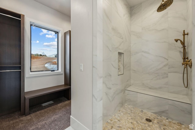 3097 E Corral Peak Cir Unit 145, Heber City, UT 84032 - bathroom featuring visible vents, baseboards, and tiled shower