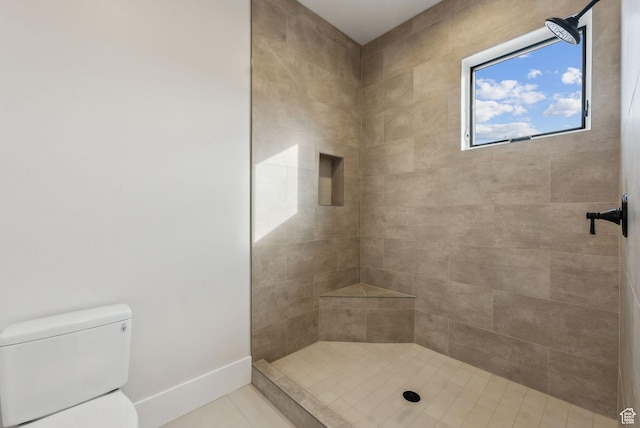 3097 E Corral Peak Cir Unit 145, Heber City, UT 84032 - bathroom featuring a tile shower, tile patterned floors, toilet, and baseboards