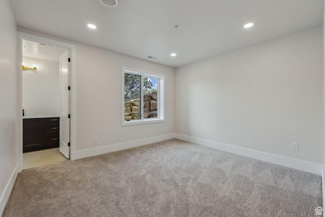 3097 E Corral Peak Cir Unit 145, Heber City, UT 84032 - spare room featuring visible vents, baseboards, recessed lighting, and light colored carpet