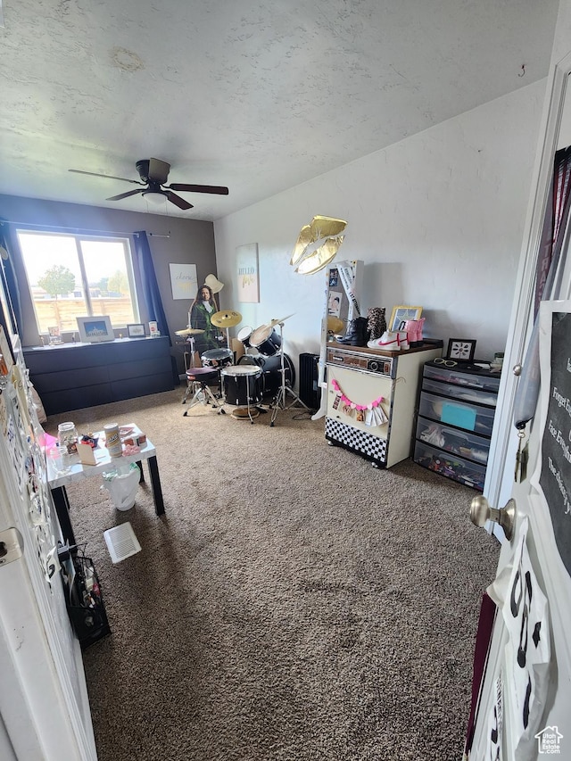 bedroom featuring carpet, a textured ceiling, and ceiling fan