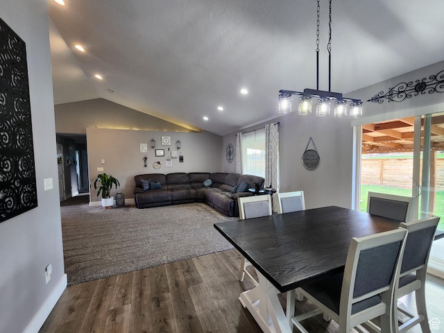 dining space featuring vaulted ceiling and hardwood / wood-style flooring