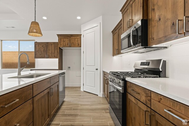 3594 W 185 N, Hurricane, UT 84737 - kitchen with pendant lighting, light stone counters, sink, and stainless steel appliances