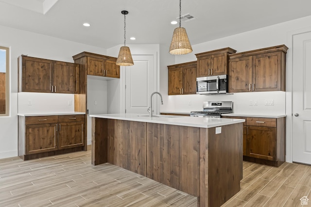 3594 W 185 N, Hurricane, UT 84737 - kitchen featuring sink, an island with sink, pendant lighting, and appliances with stainless steel finishes