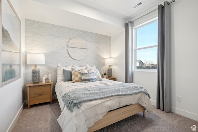 bedroom featuring visible vents, baseboards, carpet flooring, and wallpapered walls