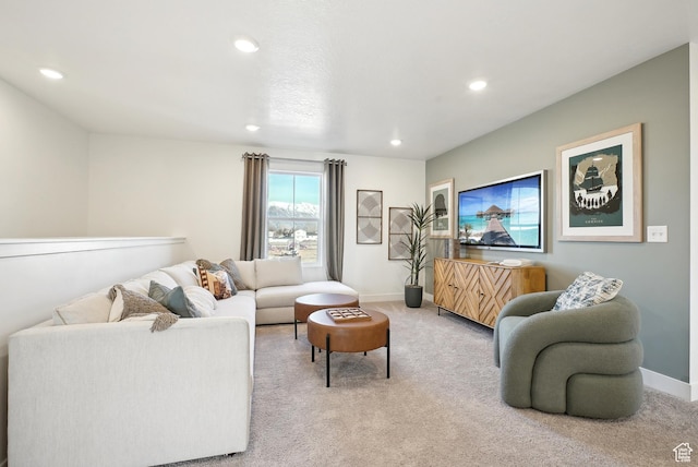 living room featuring baseboards, recessed lighting, and light colored carpet