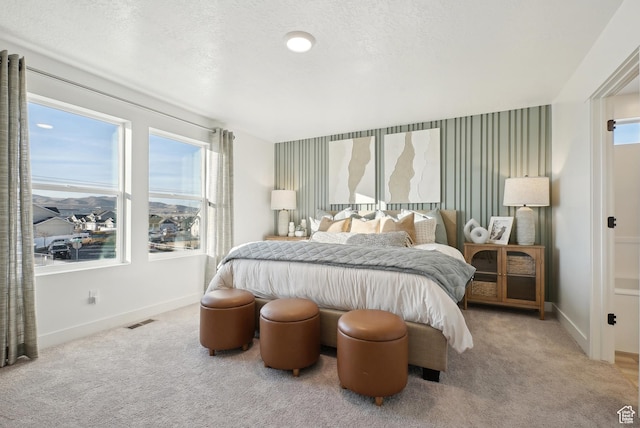 bedroom featuring baseboards, carpet, and visible vents