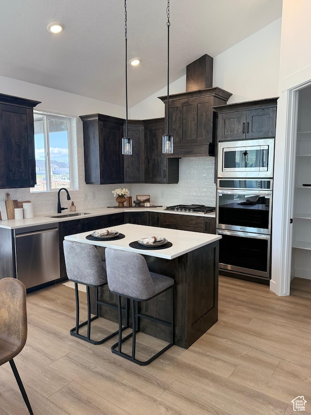 1520 E Parker Ln Unit 422, Lake Point, UT 84074 - kitchen with a sink, light wood finished floors, light countertops, stainless steel appliances, and backsplash