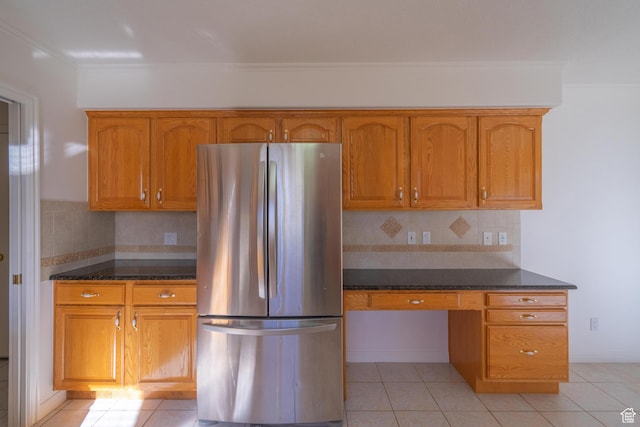 3423 Red Butte Dr, Santa Clara, UT 84765 - kitchen featuring brown cabinetry, built in desk, freestanding refrigerator, and light tile patterned floors