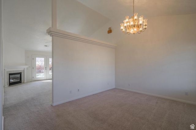 3423 Red Butte Dr, Santa Clara, UT 84765 - carpeted empty room featuring a fireplace, baseboards, an inviting chandelier, and vaulted ceiling