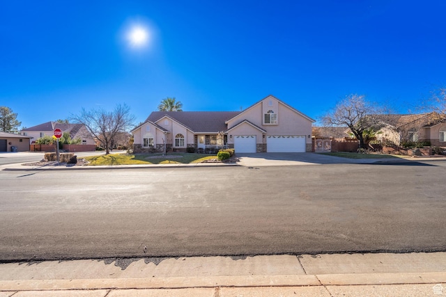 3423 Red Butte Dr, Santa Clara, UT 84765 - view of front of property featuring an attached garage, stone siding, and driveway