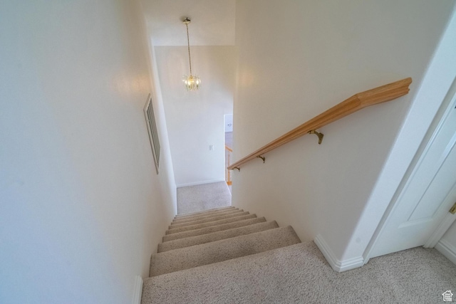 3423 Red Butte Dr, Santa Clara, UT 84765 - staircase with carpet floors and an inviting chandelier