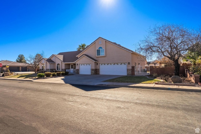3423 Red Butte Dr, Santa Clara, UT 84765 - view of front facade featuring fence, a tile roof, stucco siding, stone siding, and driveway