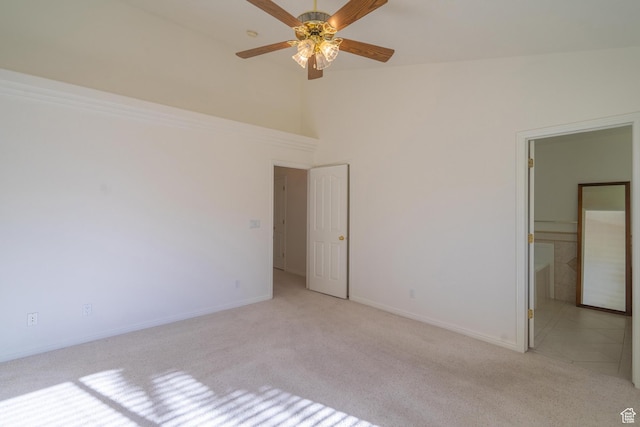 3423 Red Butte Dr, Santa Clara, UT 84765 - unfurnished bedroom with light carpet, a ceiling fan, a high ceiling, and baseboards