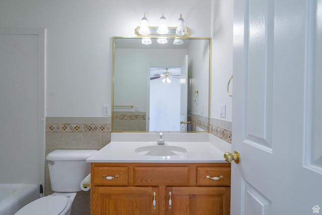 3423 Red Butte Dr, Santa Clara, UT 84765 - bathroom featuring vanity, a wainscoted wall, ceiling fan, tile walls, and toilet
