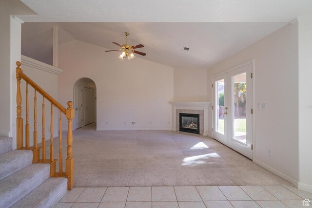 3423 Red Butte Dr, Santa Clara, UT 84765 - unfurnished living room with ceiling fan, light colored carpet, light tile patterned floors, a tile fireplace, and arched walkways