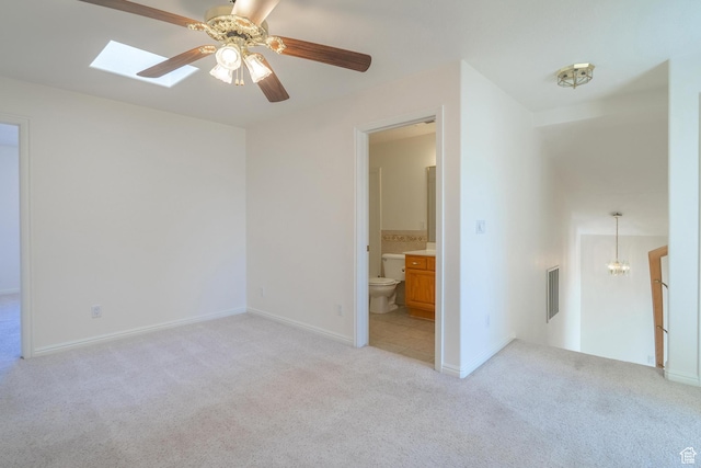 3423 Red Butte Dr, Santa Clara, UT 84765 - unfurnished bedroom featuring visible vents, baseboards, a skylight, light colored carpet, and connected bathroom