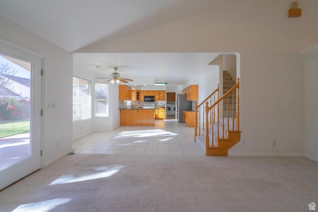3423 Red Butte Dr, Santa Clara, UT 84765 - unfurnished living room with light carpet, stairway, light tile patterned floors, lofted ceiling, and ceiling fan