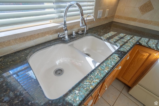 3423 Red Butte Dr, Santa Clara, UT 84765 - details with brown cabinets, dark stone counters, and a sink