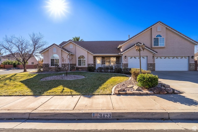 3423 Red Butte Dr, Santa Clara, UT 84765 - view of front facade featuring a front yard, an attached garage, stucco siding, concrete driveway, and a tiled roof