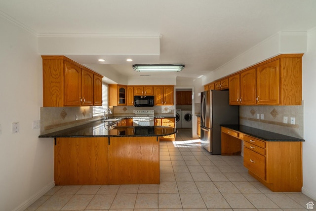 3423 Red Butte Dr, Santa Clara, UT 84765 - kitchen featuring independent washer and dryer, white range with electric cooktop, a sink, a peninsula, and black microwave