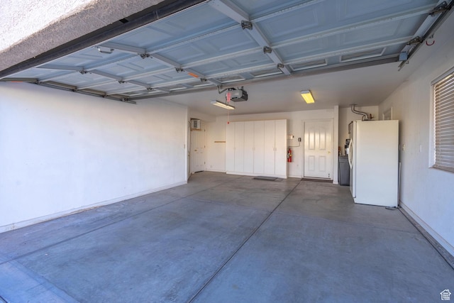 3423 Red Butte Dr, Santa Clara, UT 84765 - garage featuring a garage door opener and freestanding refrigerator