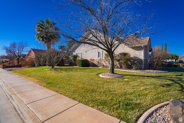 3423 Red Butte Dr, Santa Clara, UT 84765 - view of side of property featuring a yard and stucco siding