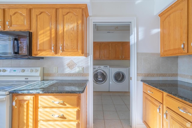 3423 Red Butte Dr, Santa Clara, UT 84765 - kitchen featuring washer and dryer, dark stone countertops, white range with electric stovetop, black microwave, and light tile patterned floors