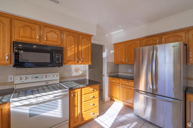 3423 Red Butte Dr, Santa Clara, UT 84765 - kitchen featuring black microwave, light tile patterned floors, brown cabinets, freestanding refrigerator, and white electric stove