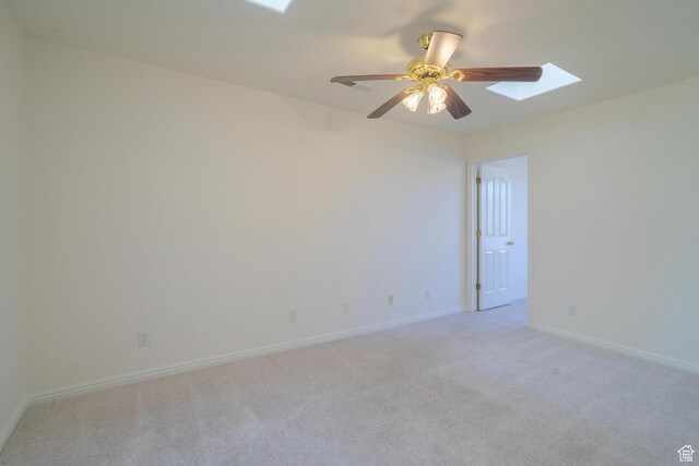 3423 Red Butte Dr, Santa Clara, UT 84765 - unfurnished room featuring light carpet, a skylight, baseboards, and a ceiling fan