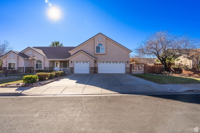 3423 Red Butte Dr, Santa Clara, UT 84765 - traditional-style house with fence, a tile roof, stucco siding, stone siding, and driveway