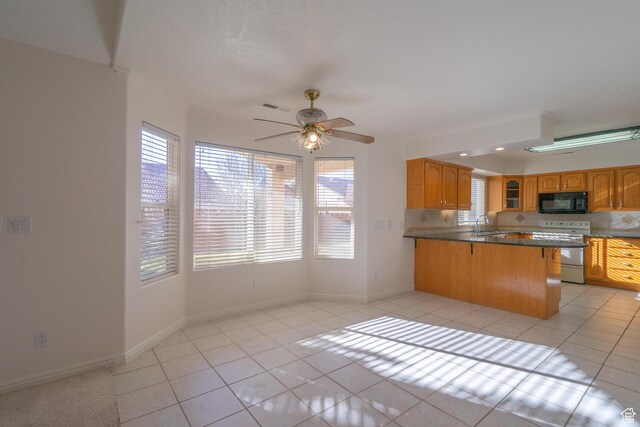 3423 Red Butte Dr, Santa Clara, UT 84765 - kitchen featuring light tile patterned floors, visible vents, white electric stove, a peninsula, and black microwave