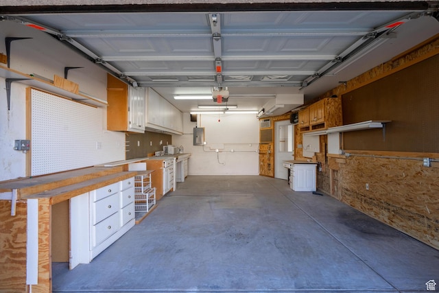 3423 Red Butte Dr, Santa Clara, UT 84765 - garage featuring electric panel, a workshop area, and a garage door opener