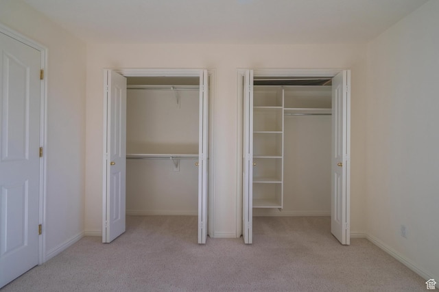 3423 Red Butte Dr, Santa Clara, UT 84765 - unfurnished bedroom with baseboards, multiple closets, and carpet