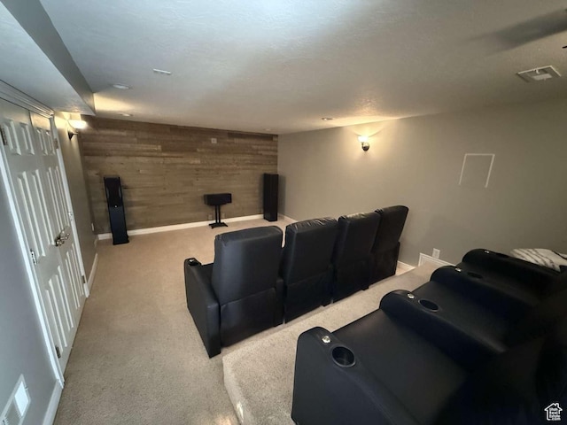 carpeted cinema room with wooden walls