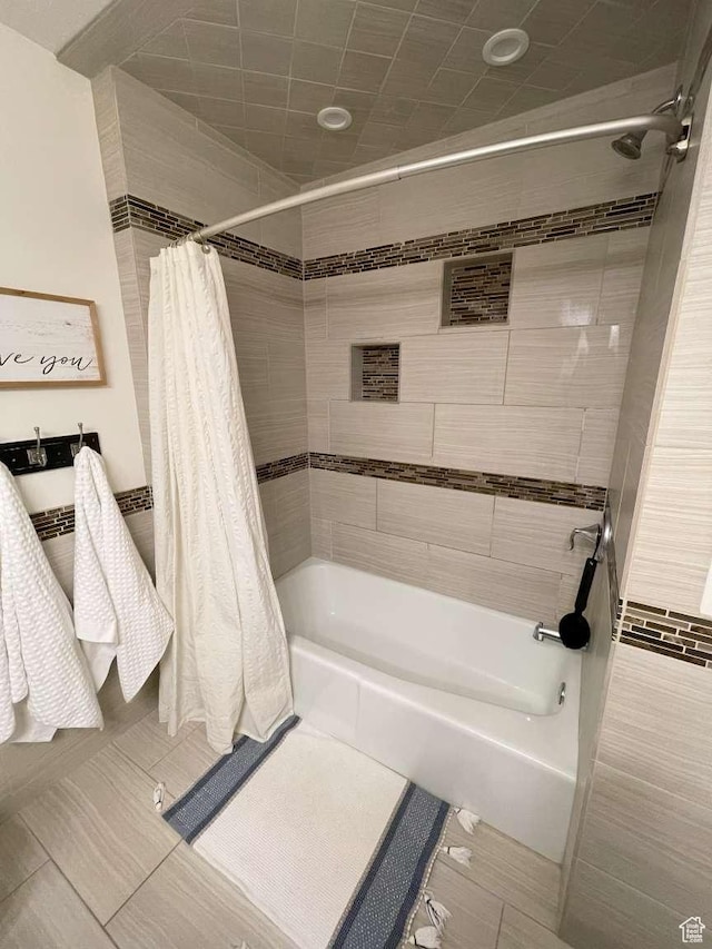 bathroom with tile patterned flooring and shower / bath combo