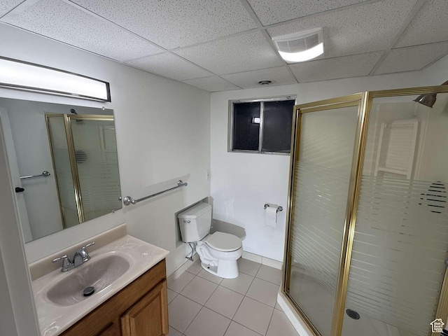 bathroom with tile patterned floors, vanity, toilet, and a shower with shower door
