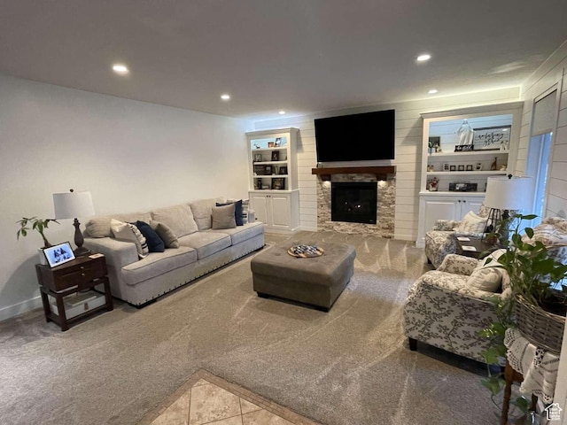 living room featuring built in shelves and a fireplace