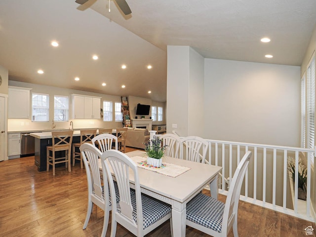 dining area featuring a fireplace, recessed lighting, light wood-style floors, and a ceiling fan