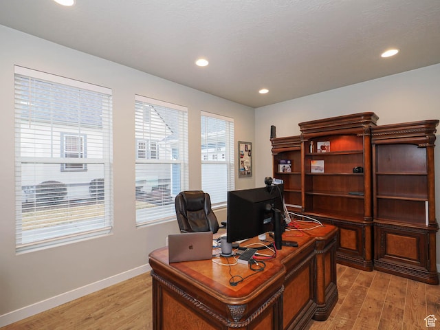office featuring baseboards, light wood finished floors, and recessed lighting