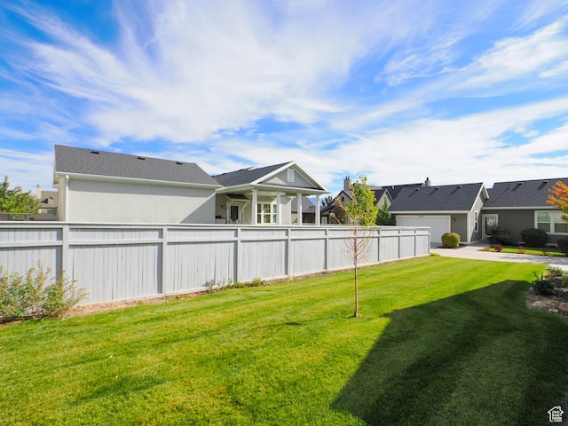 view of yard featuring fence and a residential view