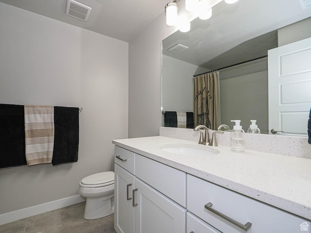 bathroom featuring vanity, baseboards, tile patterned floors, toilet, and visible vents