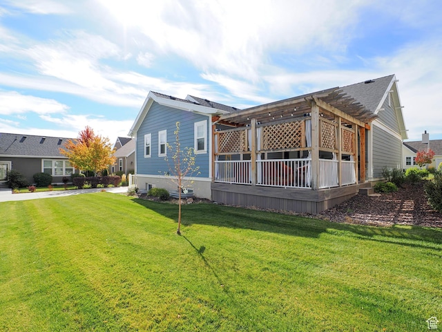 view of side of property featuring a yard and a pergola